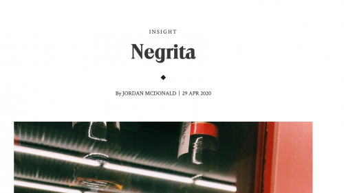 Text reading Negrita by Jordan McDonald. The bottom of the photo contains an image fragment of reflective glass