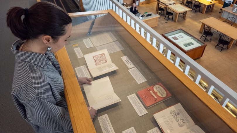 A woman looks at a Special Collections display case