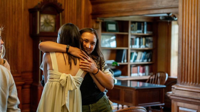Students hugging at Creative Writing Prizes Ceremony